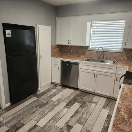 a kitchen with a sink and a refrigerator