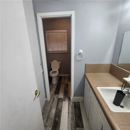 a bathroom with a sink a toilet and vanity