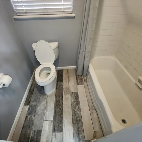 a bathroom with a toilet and a bathtub