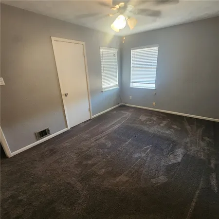 an empty room with windows and entrance