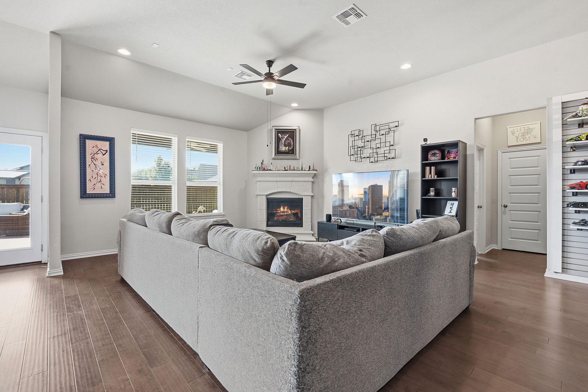 12616 Twisted Root Drive Manchaca, TX 78652 - Photo 9 of 36 The living room centers around a sleek corner fireplace while natural light pours in from every angle.