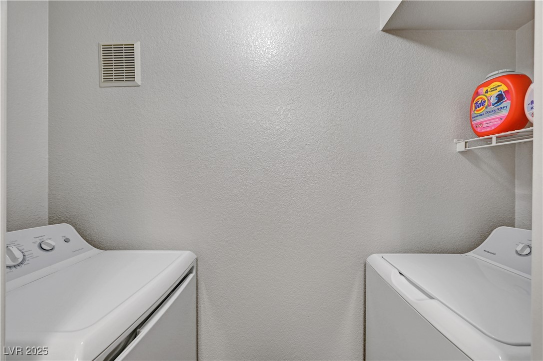 8101 West Flamingo Road, Unit 1163 Las Vegas, NV 89147 - Photo 15 of 45 Laundry area with a textured wall and independent washer and dryer