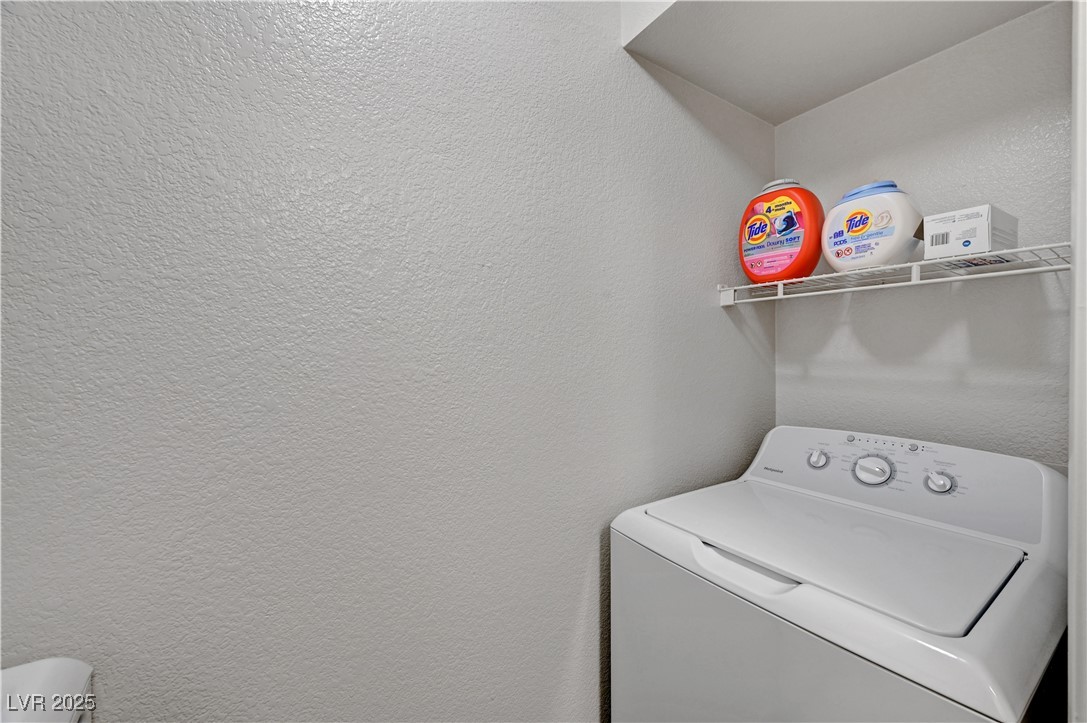 8101 West Flamingo Road, Unit 1163 Las Vegas, NV 89147 - Photo 16 of 45 Washroom featuring washer / clothes dryer and a textured wall