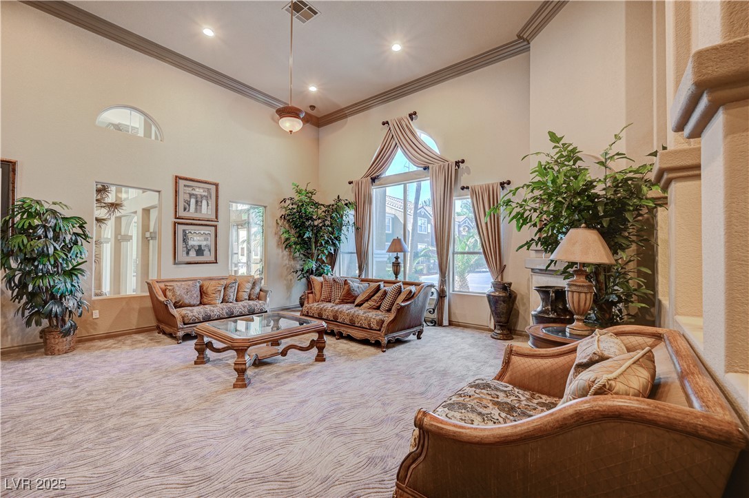 8101 West Flamingo Road, Unit 1163 Las Vegas, NV 89147 - Photo 40 of 45 Living area with a towering ceiling, crown molding, carpet, and recessed lighting