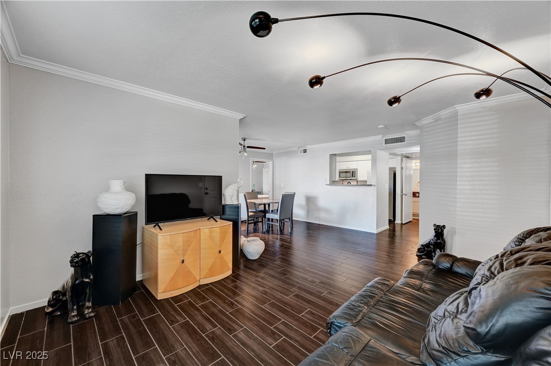 8101 West Flamingo Road, Unit 1163 Las Vegas, NV 89147 - Photo 6 of 45 Living room with ornamental molding and wood tiled floors
