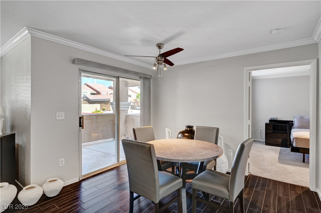 8101 West Flamingo Road, Unit 1163 Las Vegas, NV 89147 - Photo 7 of 45 Dining room featuring wood finish floors, ornamental molding, and a ceiling fan