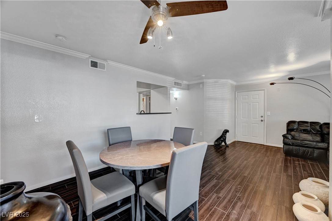 8101 West Flamingo Road, Unit 1163 Las Vegas, NV 89147 - Photo 9 of 45 Dining space with wood tiled floors, ornamental molding, and ceiling fan