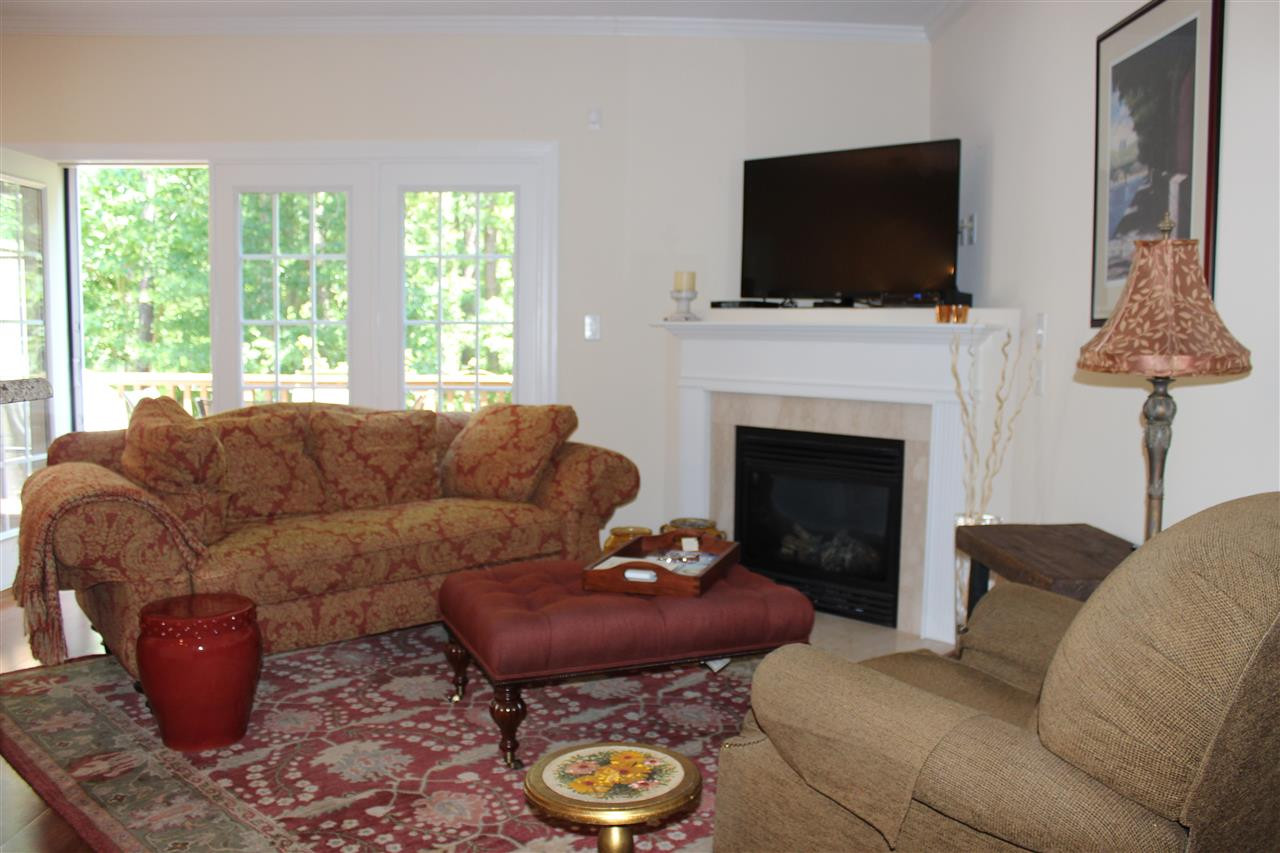 2822 Pickett Road, Unit 169 Durham, NC 27705 - Photo 5 of 17 Relax by the fireplace or enjoy the view of the backyard in this inviting living room. Living Room