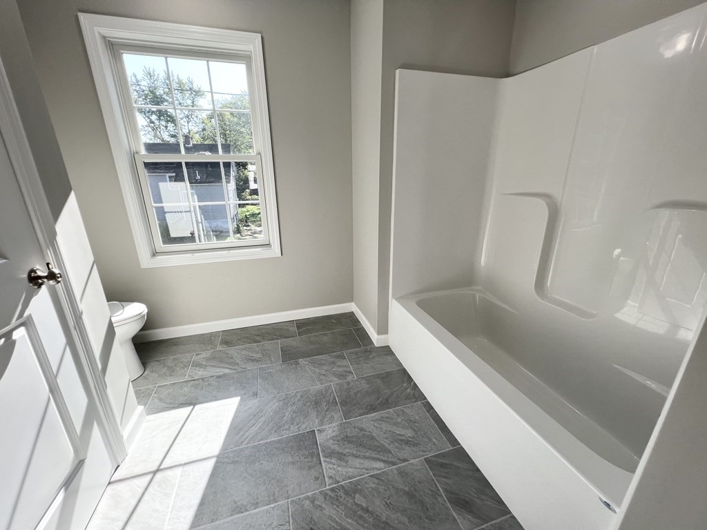 8 Francis Street Springfield, MA 01104 - Photo 28 of 41 a bathroom with a tub shower and toilet