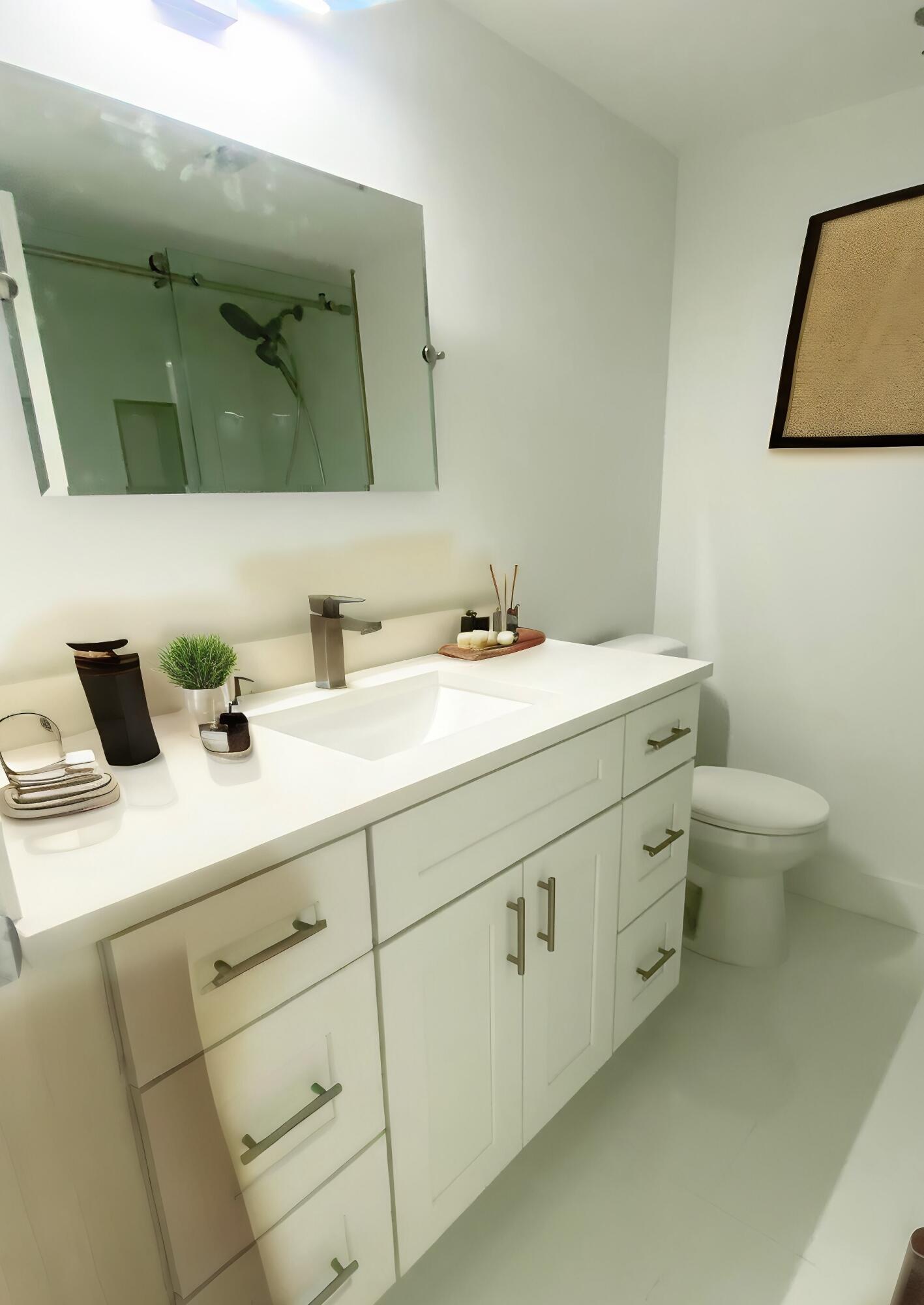 9170 Southwest 14th Street, Unit 4405 Boca Raton, FL 33428 - Photo 21 of 48 a bathroom with a sink and a mirror