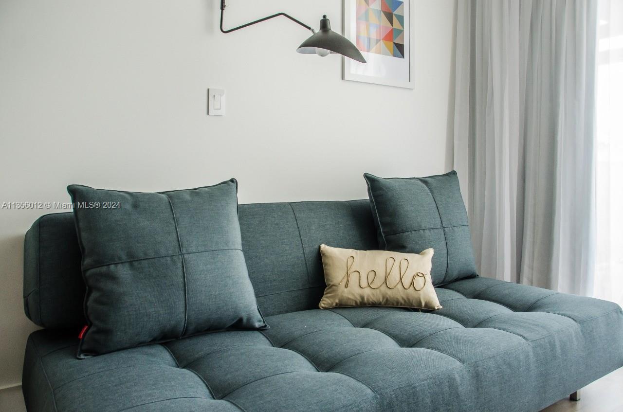 1215 West Avenue, Unit 306 Miami Beach, FL 33139 - Photo 13 of 18 a living room with furniture and a window