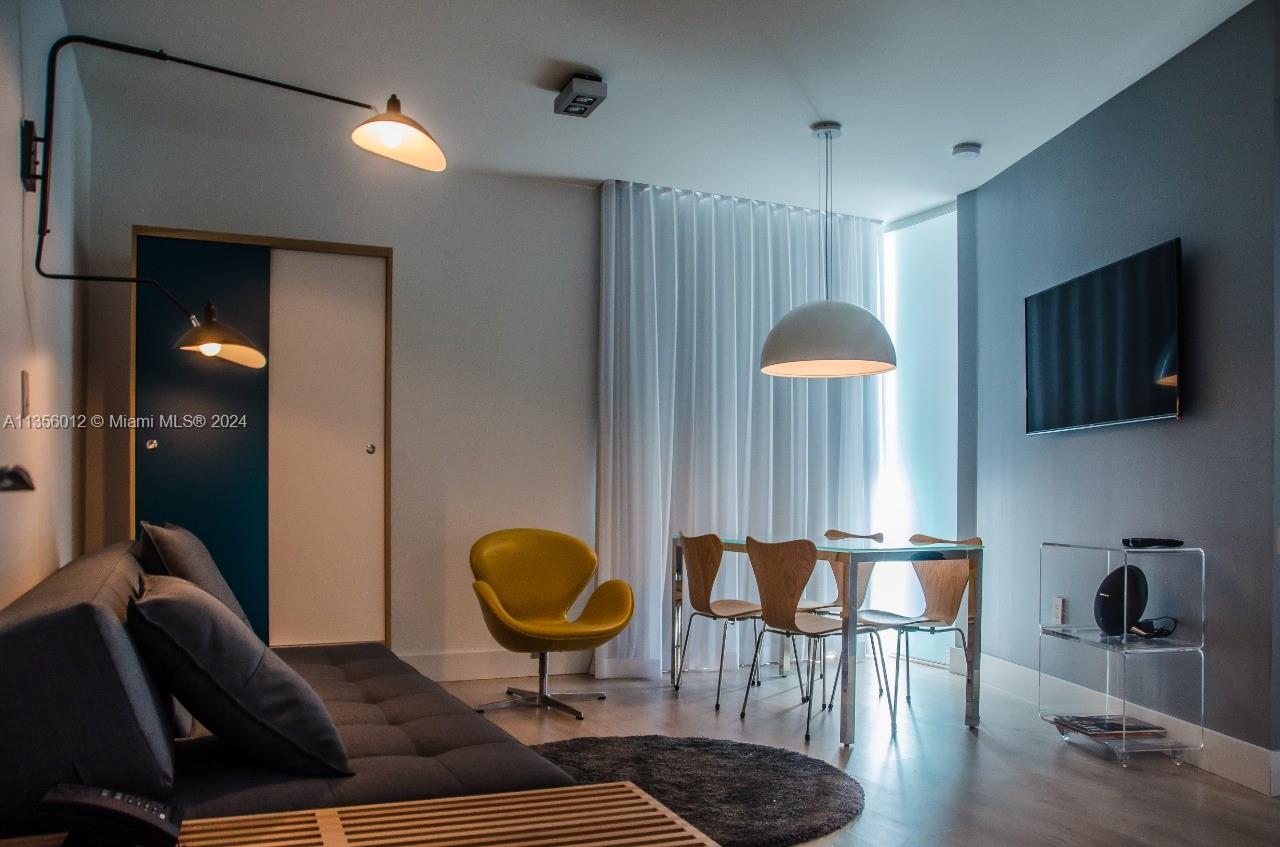 1215 West Avenue, Unit 306 Miami Beach, FL 33139 - Photo 3 of 18 a living room with furniture and a fireplace