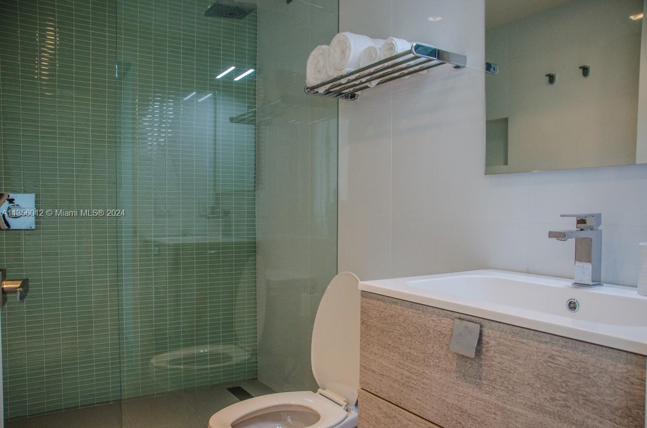 1215 West Avenue, Unit 306 Miami Beach, FL 33139 - Photo 6 of 18 a bathroom with a sink toilet and shower