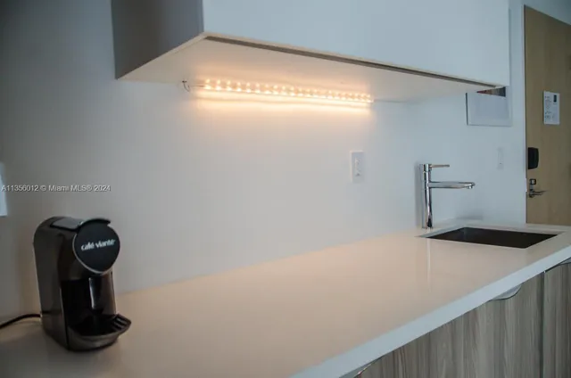 a view of a bathroom with a sink and mirror