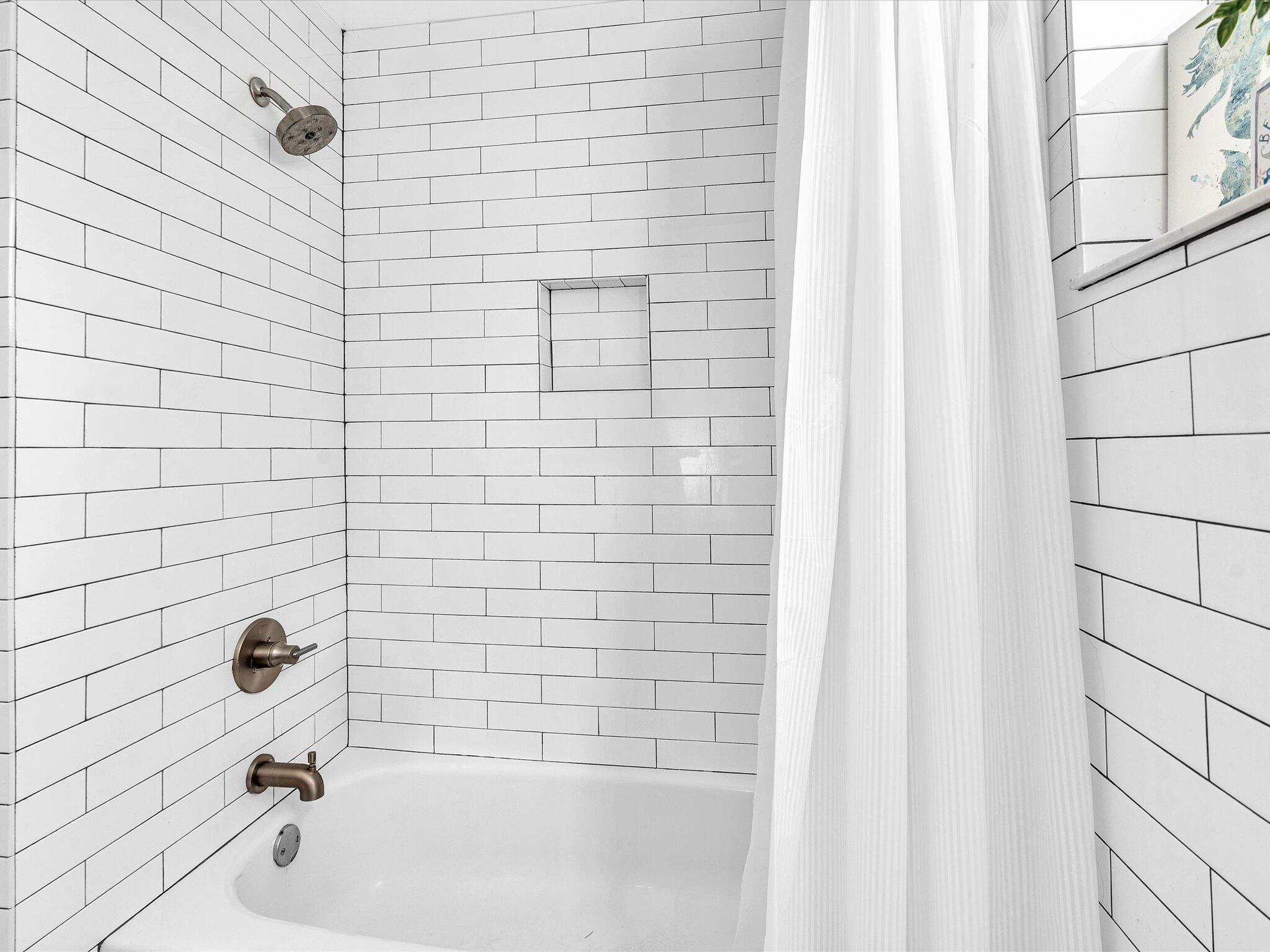 4441 Northwest 22nd Road, Unit 414 Coconut Creek, FL 33066 - Photo 25 of 60 a bathroom with a bathtub and a shower