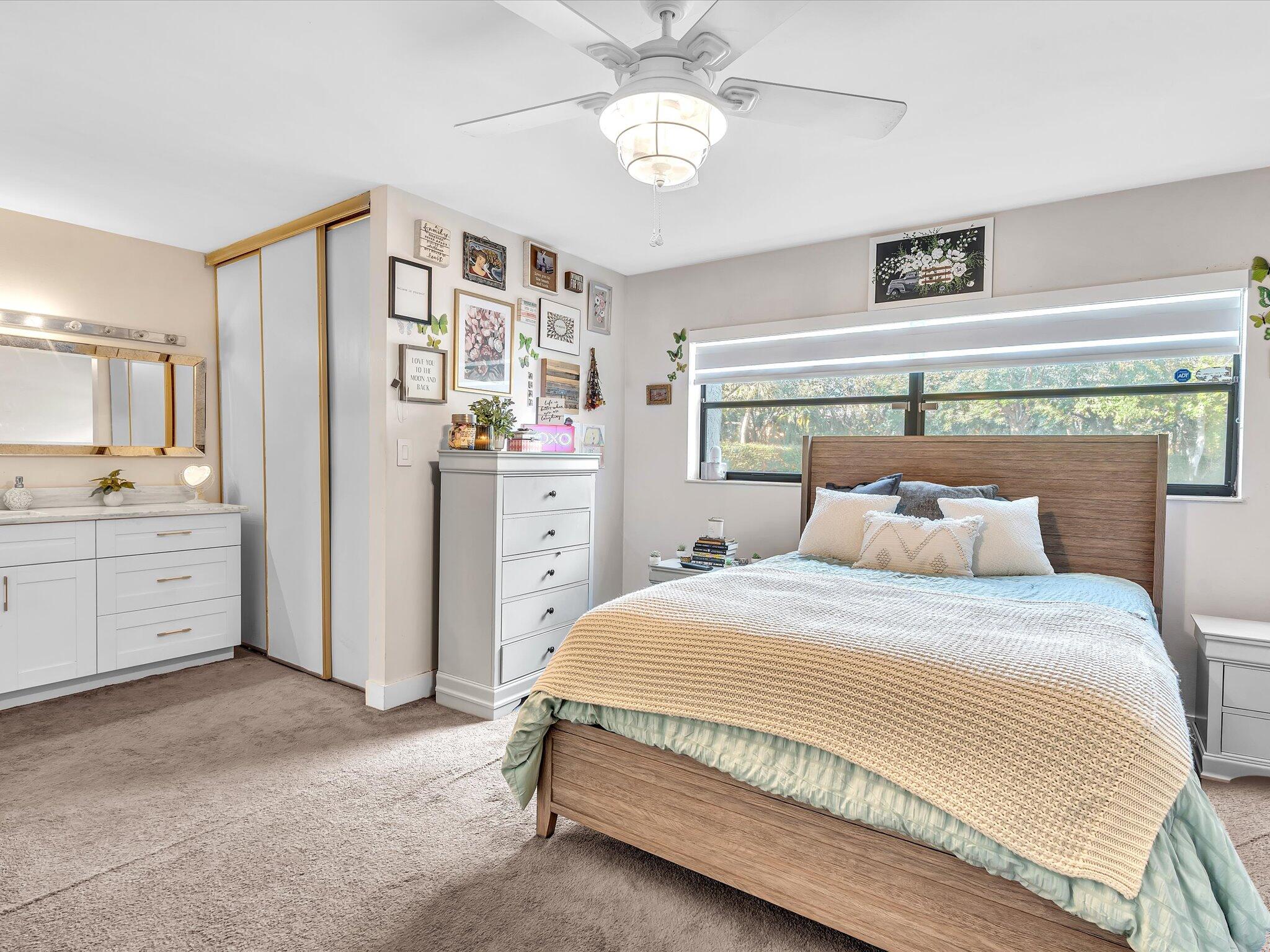 4441 Northwest 22nd Road, Unit 414 Coconut Creek, FL 33066 - Photo 26 of 60 a bedroom with a large bed and a window