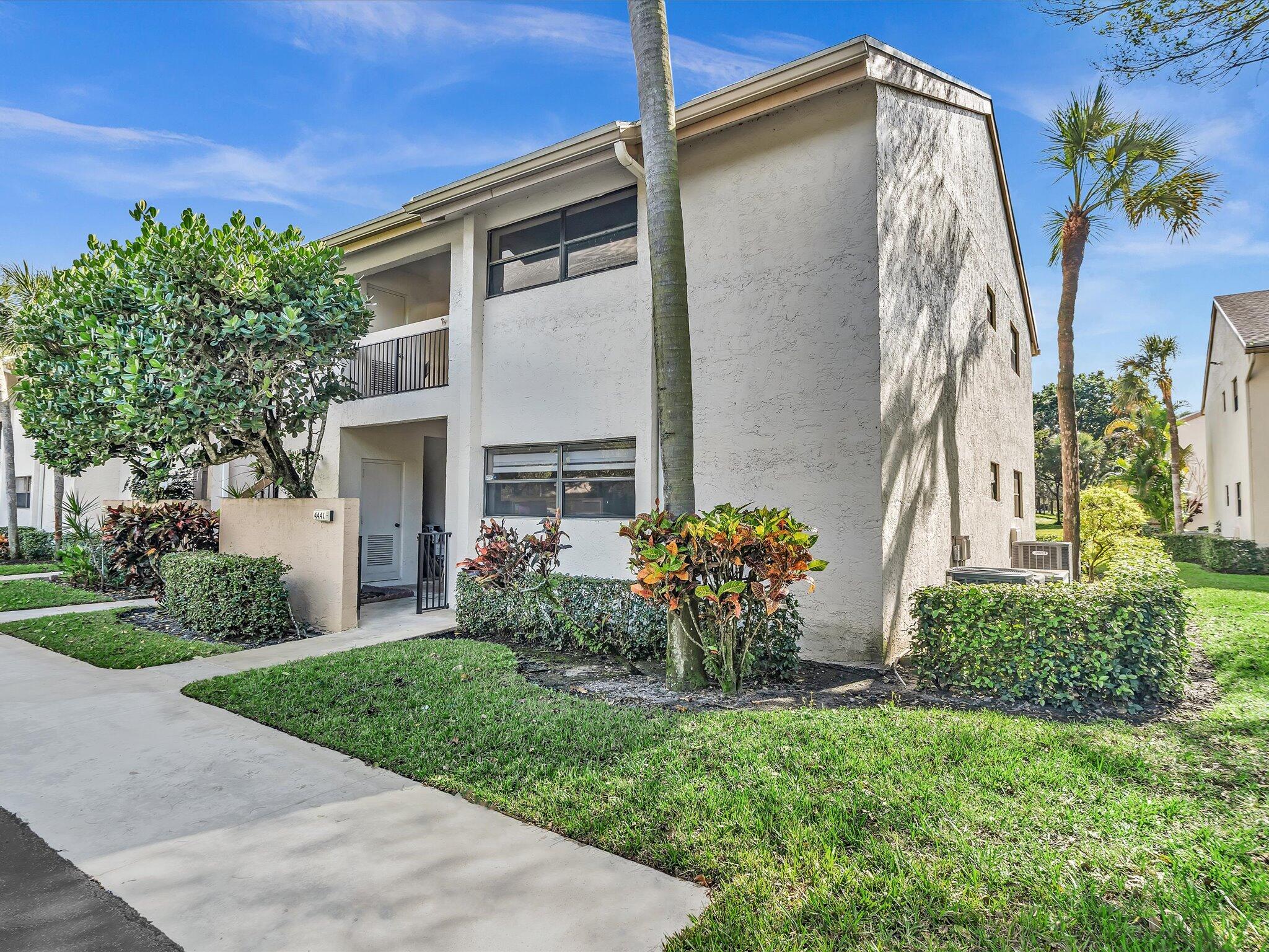 4441 Northwest 22nd Road, Unit 414 Coconut Creek, FL 33066 - Photo 3 of 60 a front view of house with yard