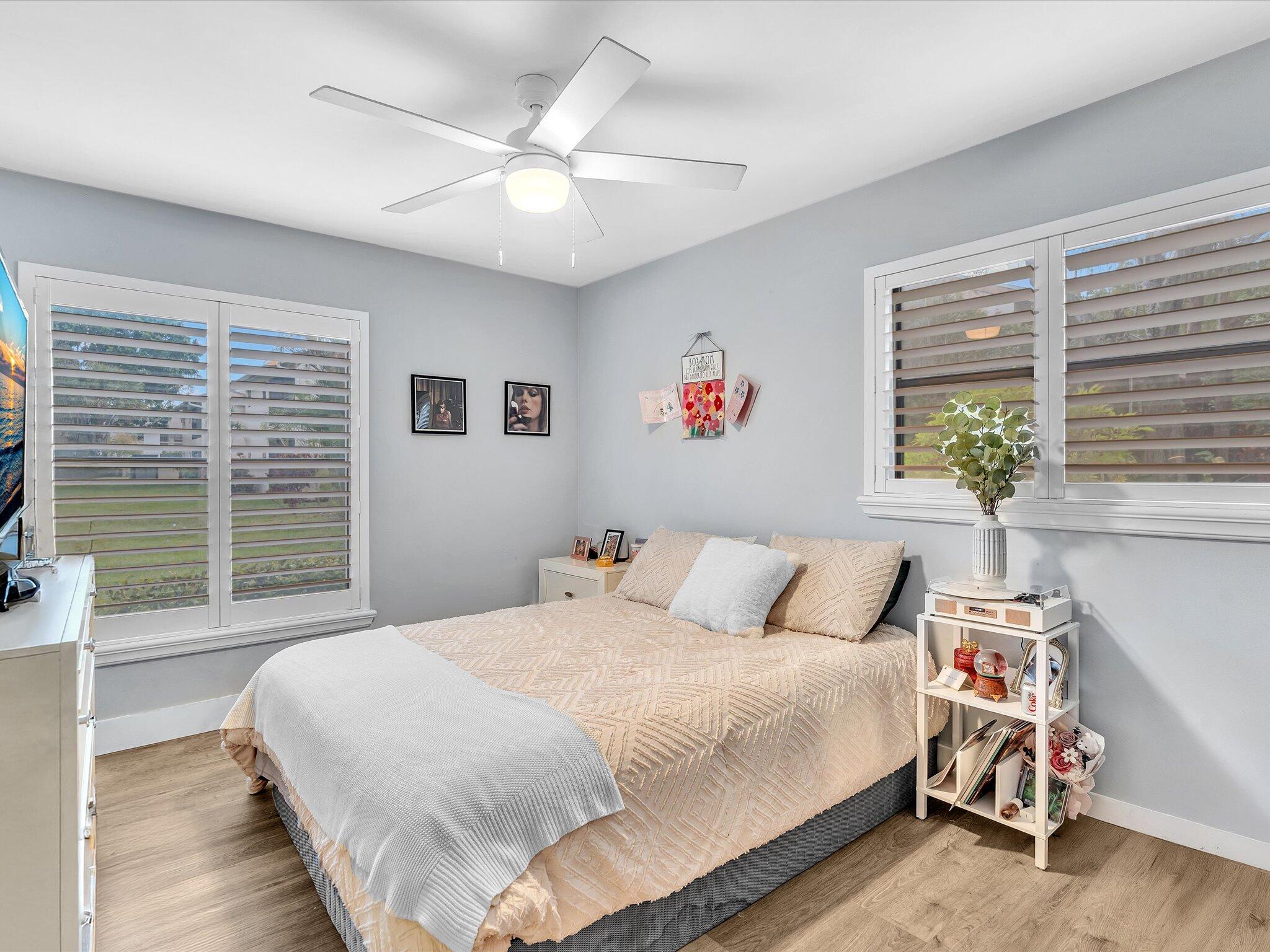 4441 Northwest 22nd Road, Unit 414 Coconut Creek, FL 33066 - Photo 31 of 60 a bedroom with a bed and a large window