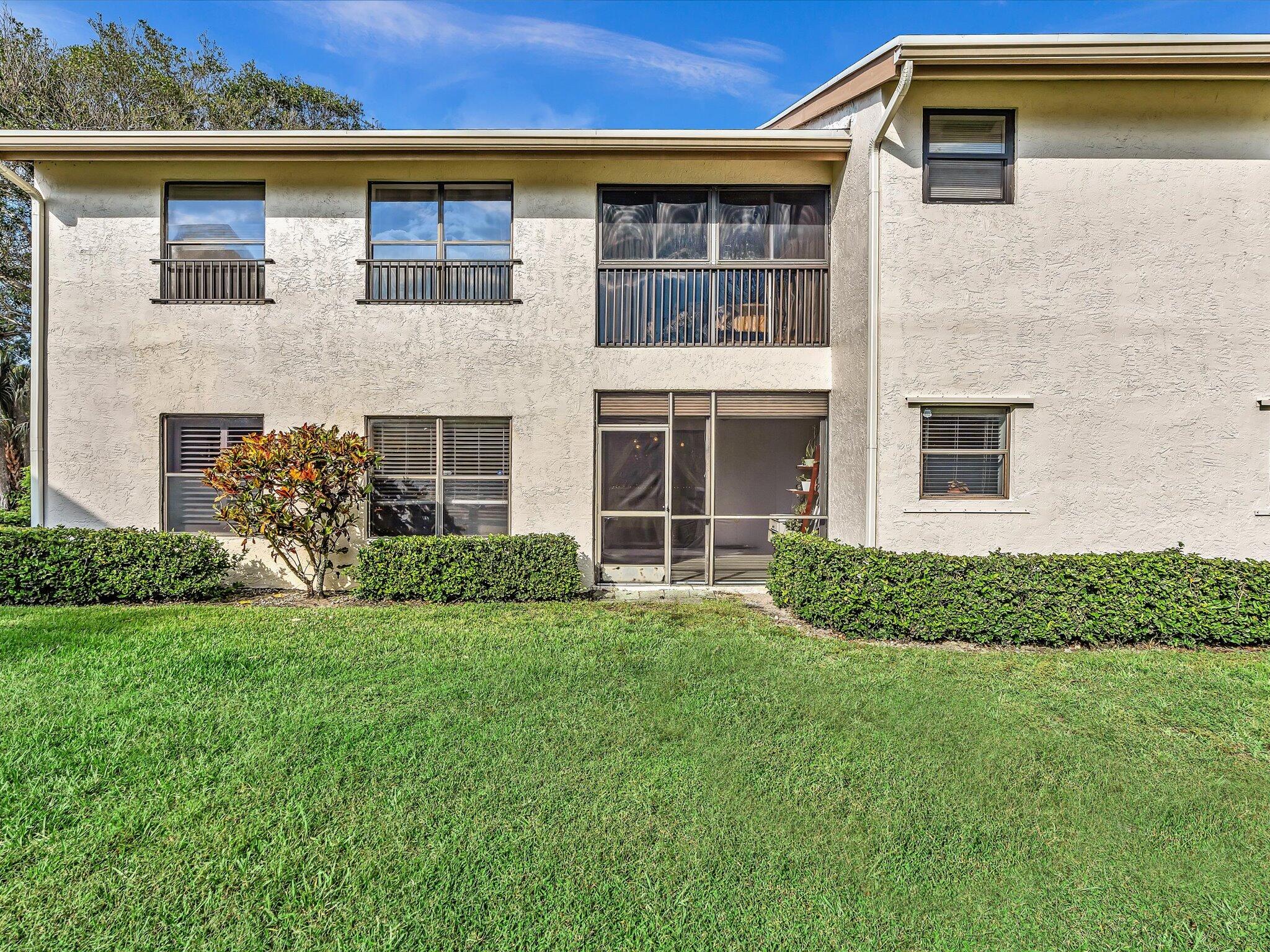 4441 Northwest 22nd Road, Unit 414 Coconut Creek, FL 33066 - Photo 38 of 60 a front view of a house with a yard
