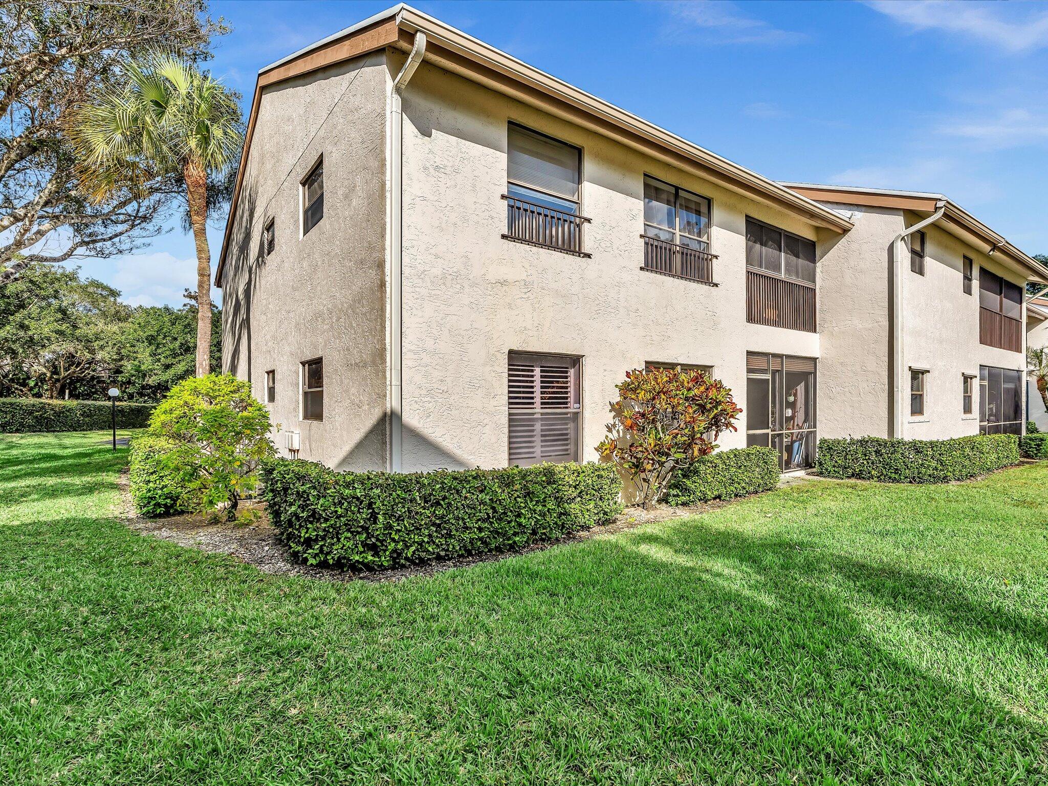 4441 Northwest 22nd Road, Unit 414 Coconut Creek, FL 33066 - Photo 39 of 60 a front view of a house with a yard