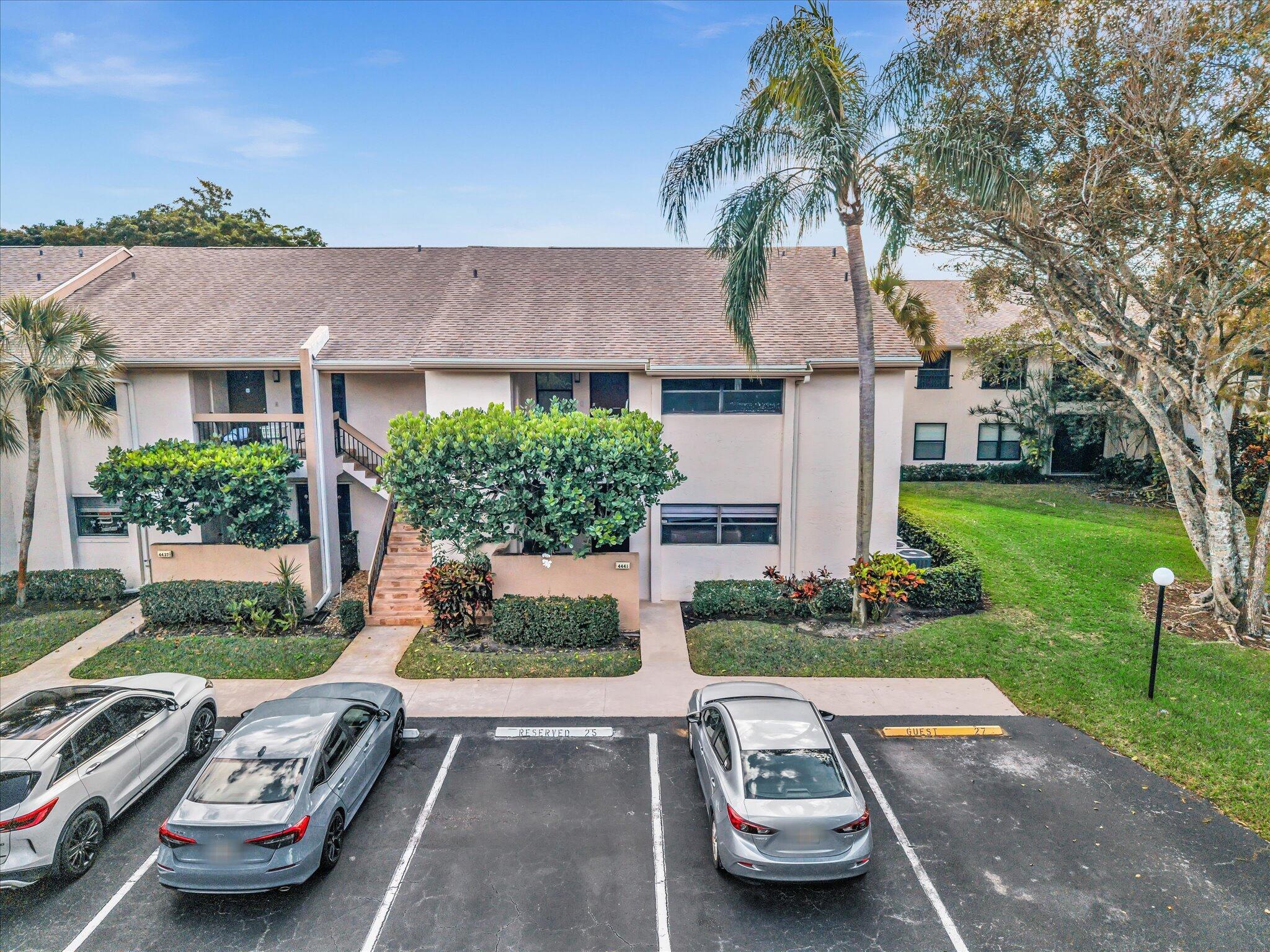 4441 Northwest 22nd Road, Unit 414 Coconut Creek, FL 33066 - Photo 41 of 60 a front view of a house with a garden