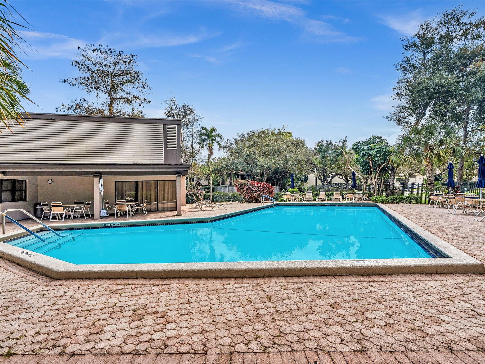 4441 Northwest 22nd Road, Unit 414 Coconut Creek, FL 33066 - Photo 46 of 60 a view of swimming pool with outdoor seating