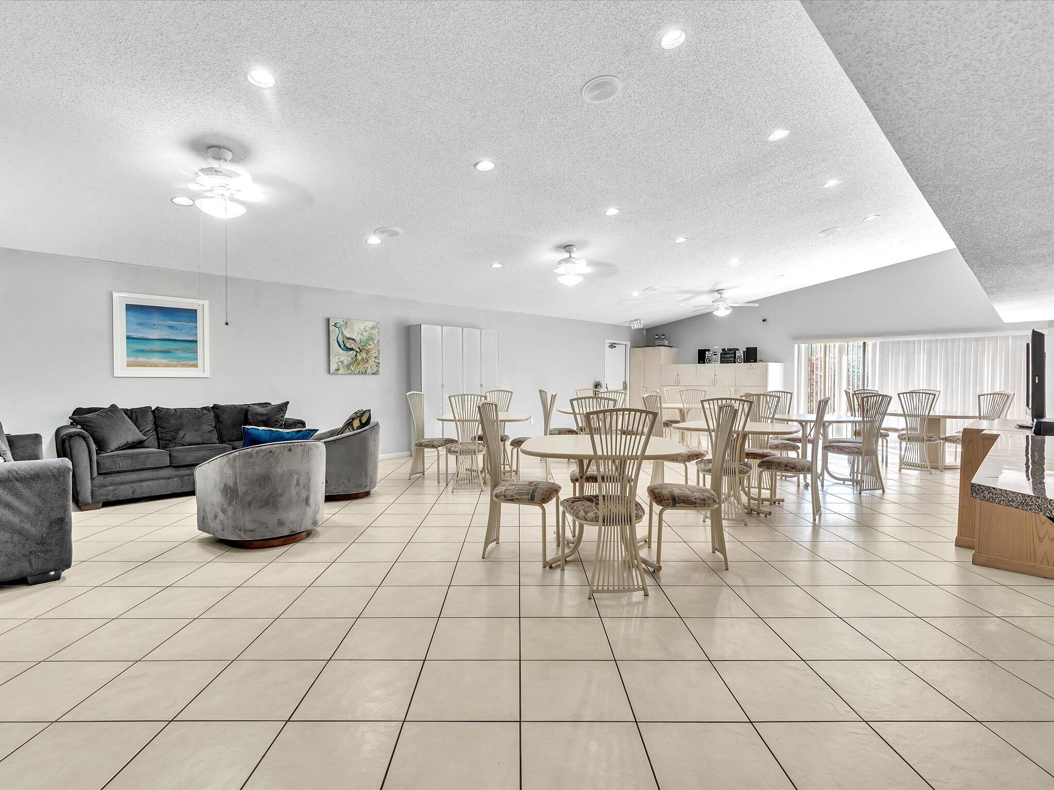 4441 Northwest 22nd Road, Unit 414 Coconut Creek, FL 33066 - Photo 49 of 60 a living room with lots of furniture and view of kitchen