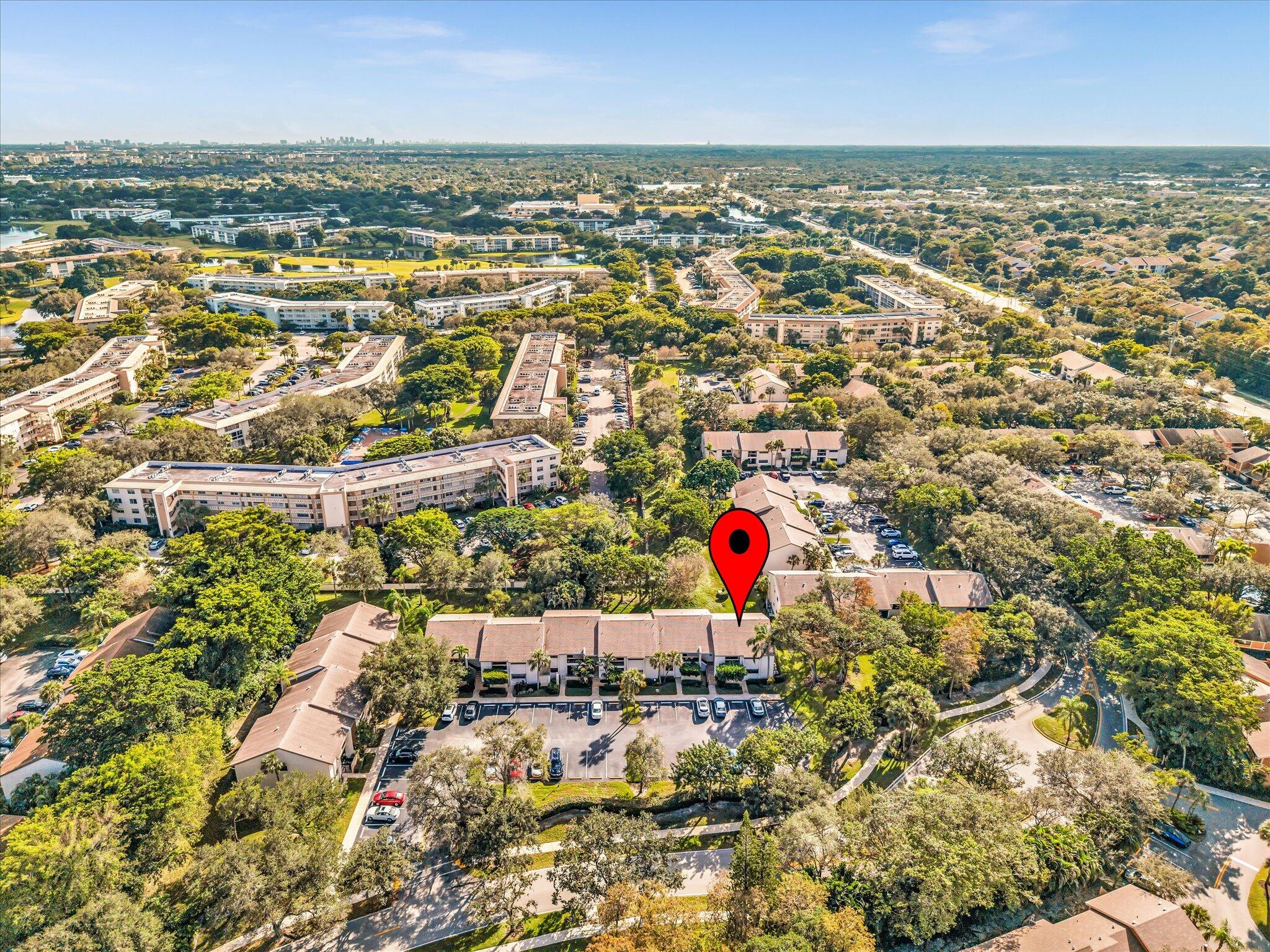 4441 Northwest 22nd Road, Unit 414 Coconut Creek, FL 33066 - Photo 58 of 60 an aerial view of residential houses with yard