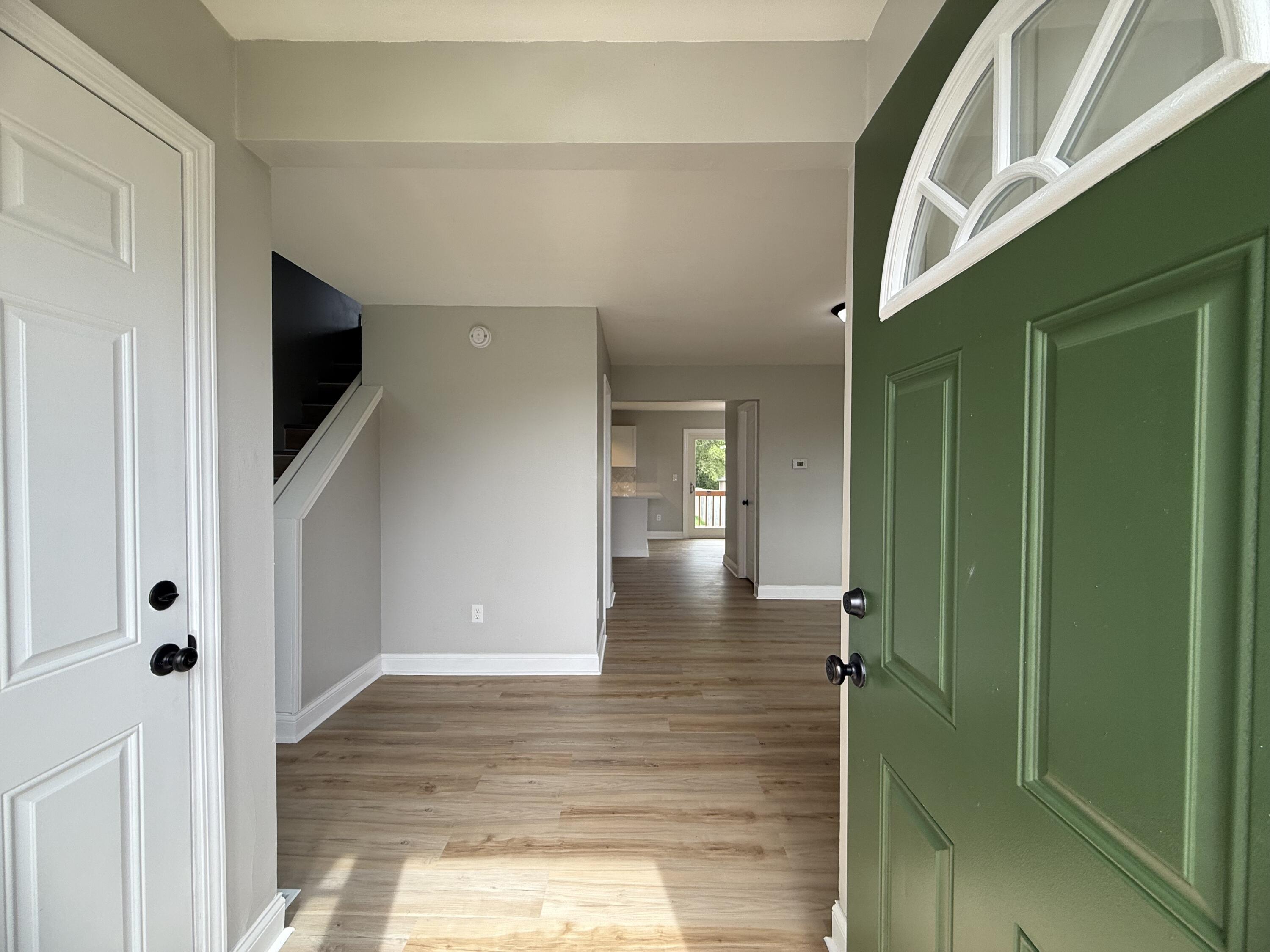 15895 Sherman Street Lowell, IN 46356 - Photo 3 of 36 a view of a hallway with wooden floor and staircase