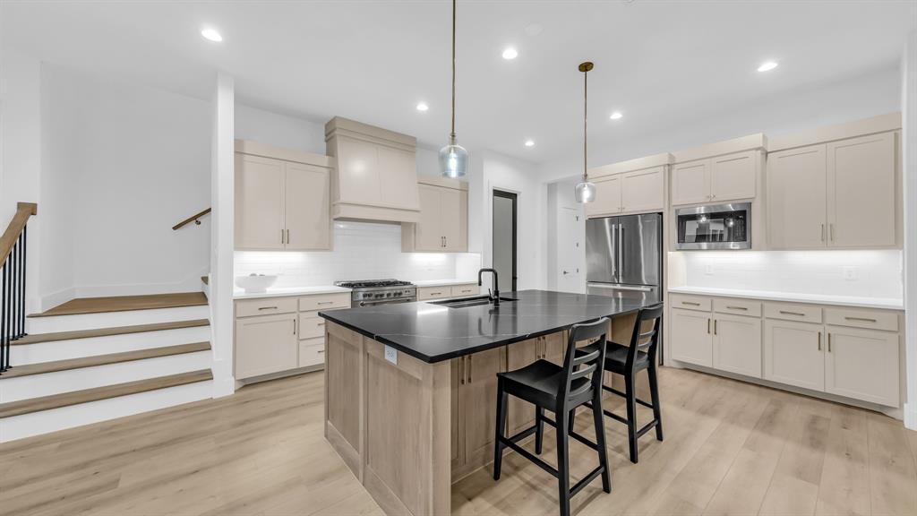 141 Lakeside Drive Lipan, TX 76462 - Photo 11 of 25 a kitchen with stainless steel appliances kitchen island granite countertop a table chairs sink and cabinets