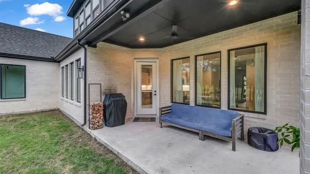 a view of porch with furniture and a gate