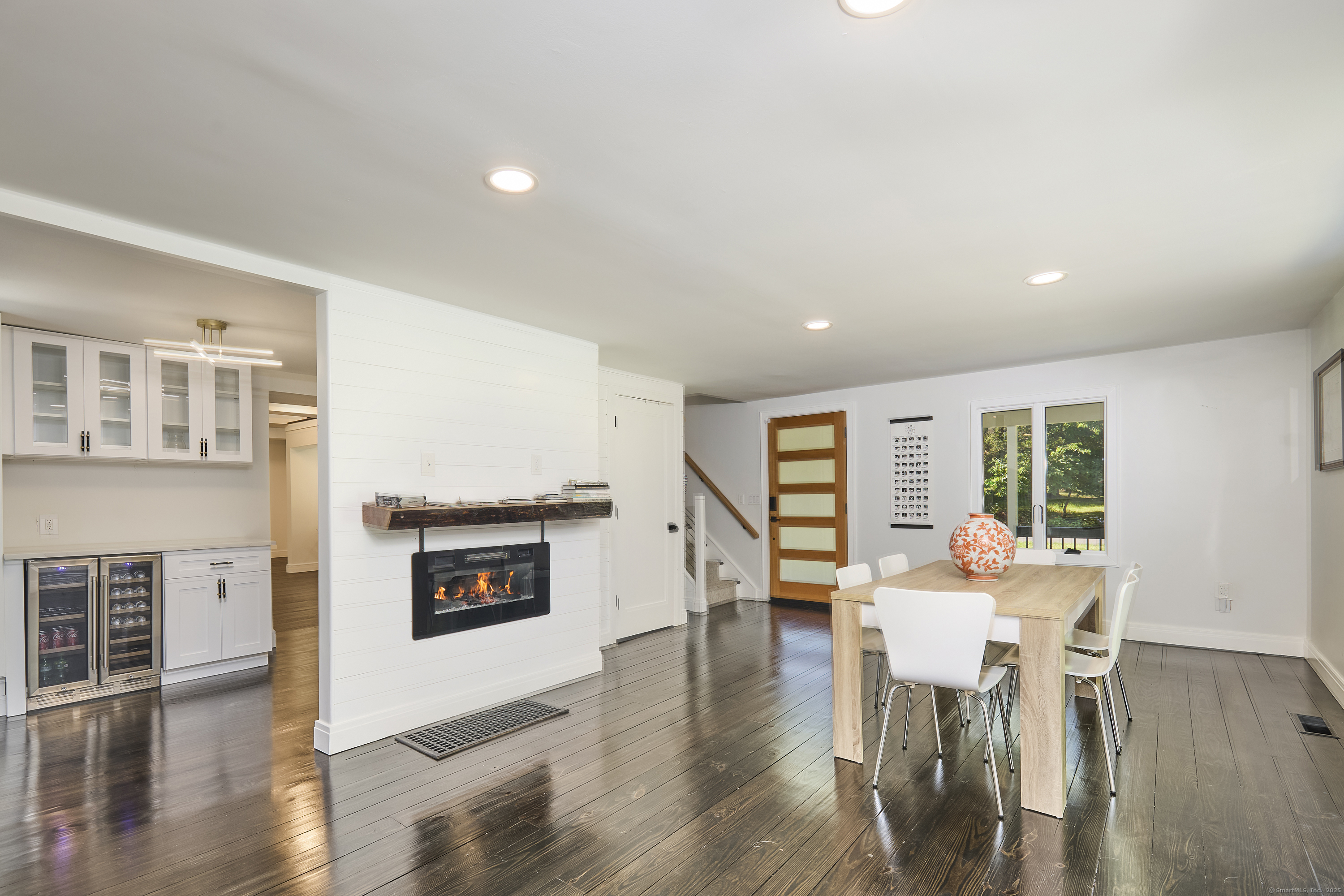 1207 Stillson Road Fairfield, CT 06824 - Photo 14 of 39 a living room with furniture a fireplace and wooden floor