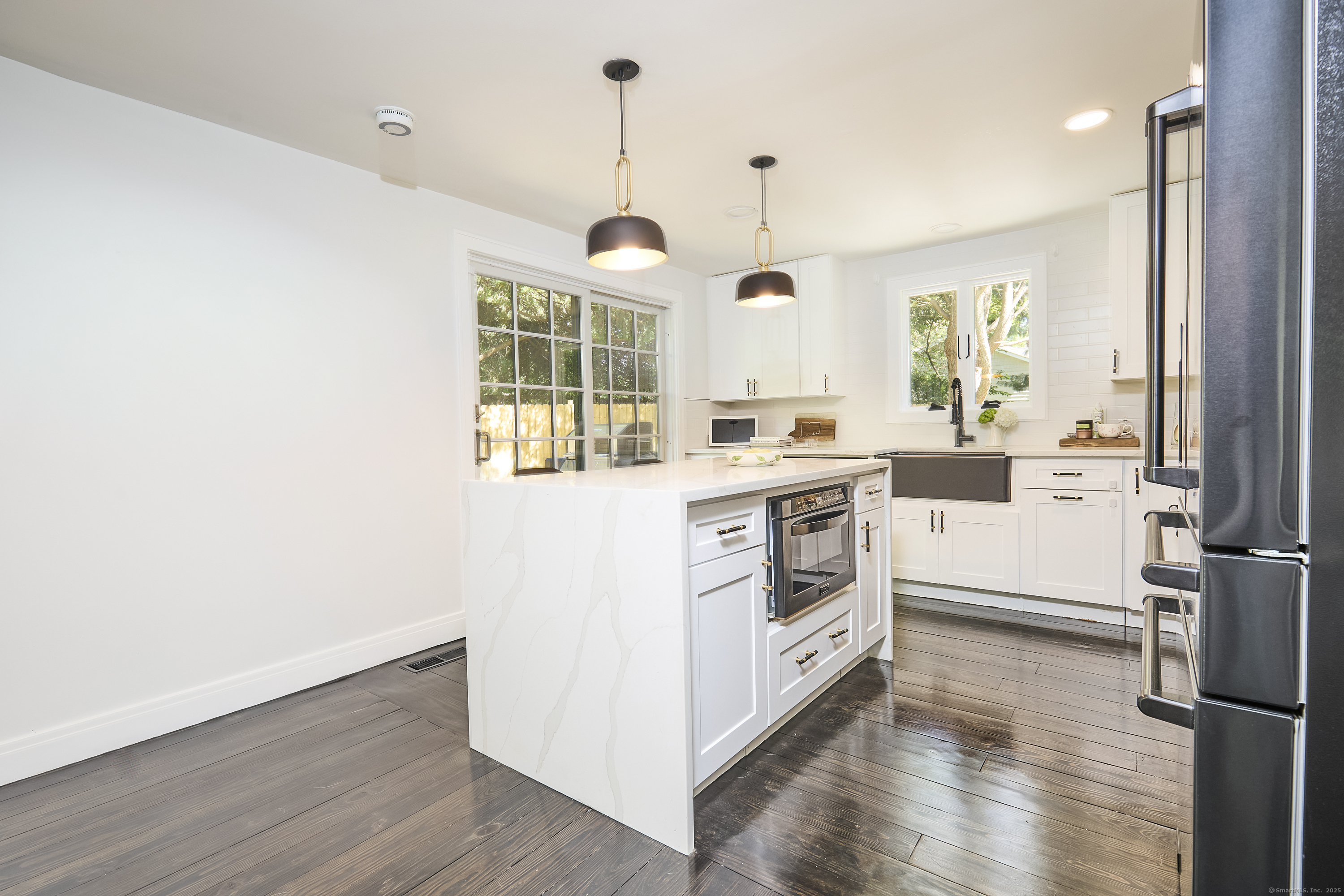 1207 Stillson Road Fairfield, CT 06824 - Photo 17 of 39 a kitchen with a stove a sink and wooden floor