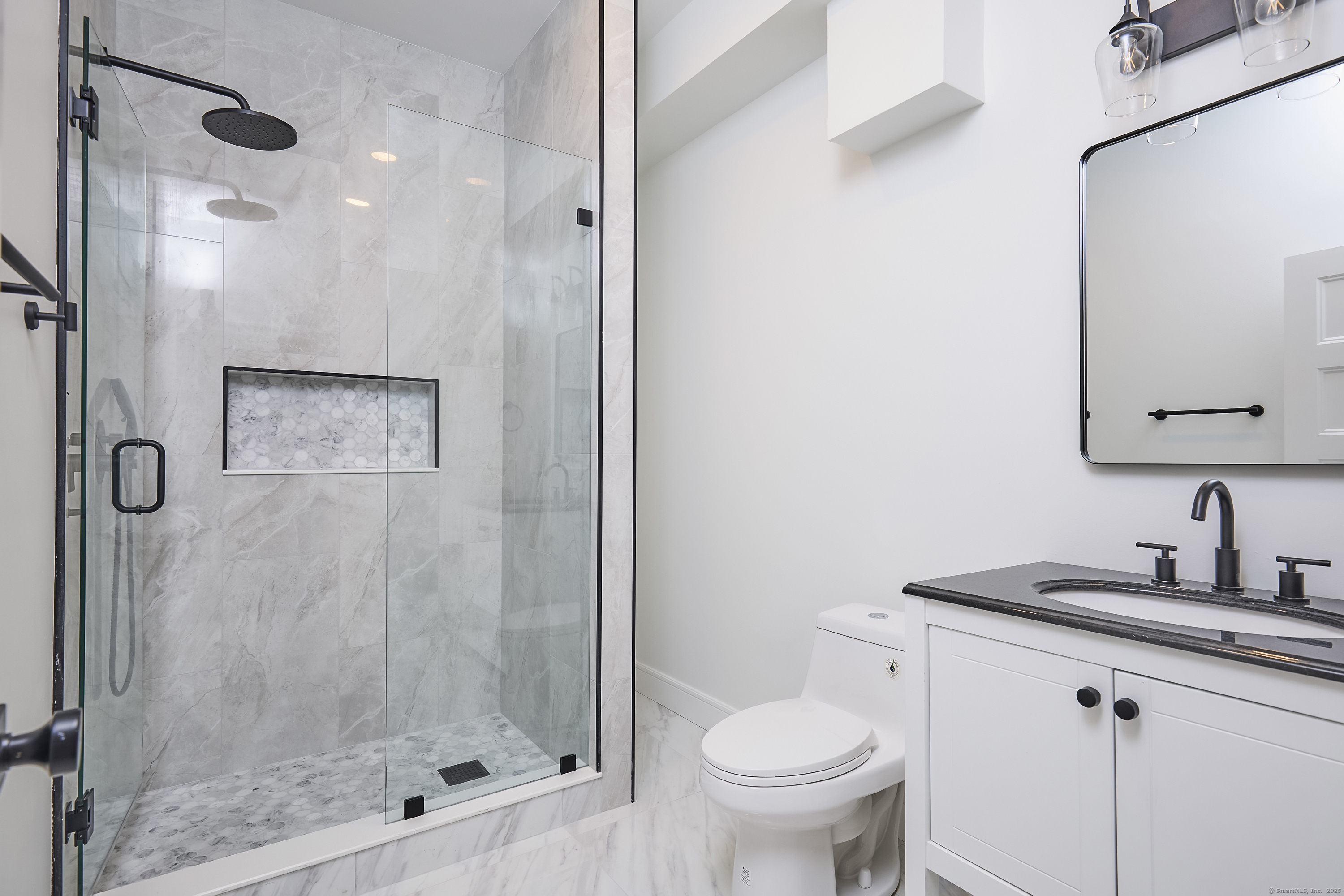 1207 Stillson Road Fairfield, CT 06824 - Photo 20 of 39 a bathroom with a shower toilet and sink