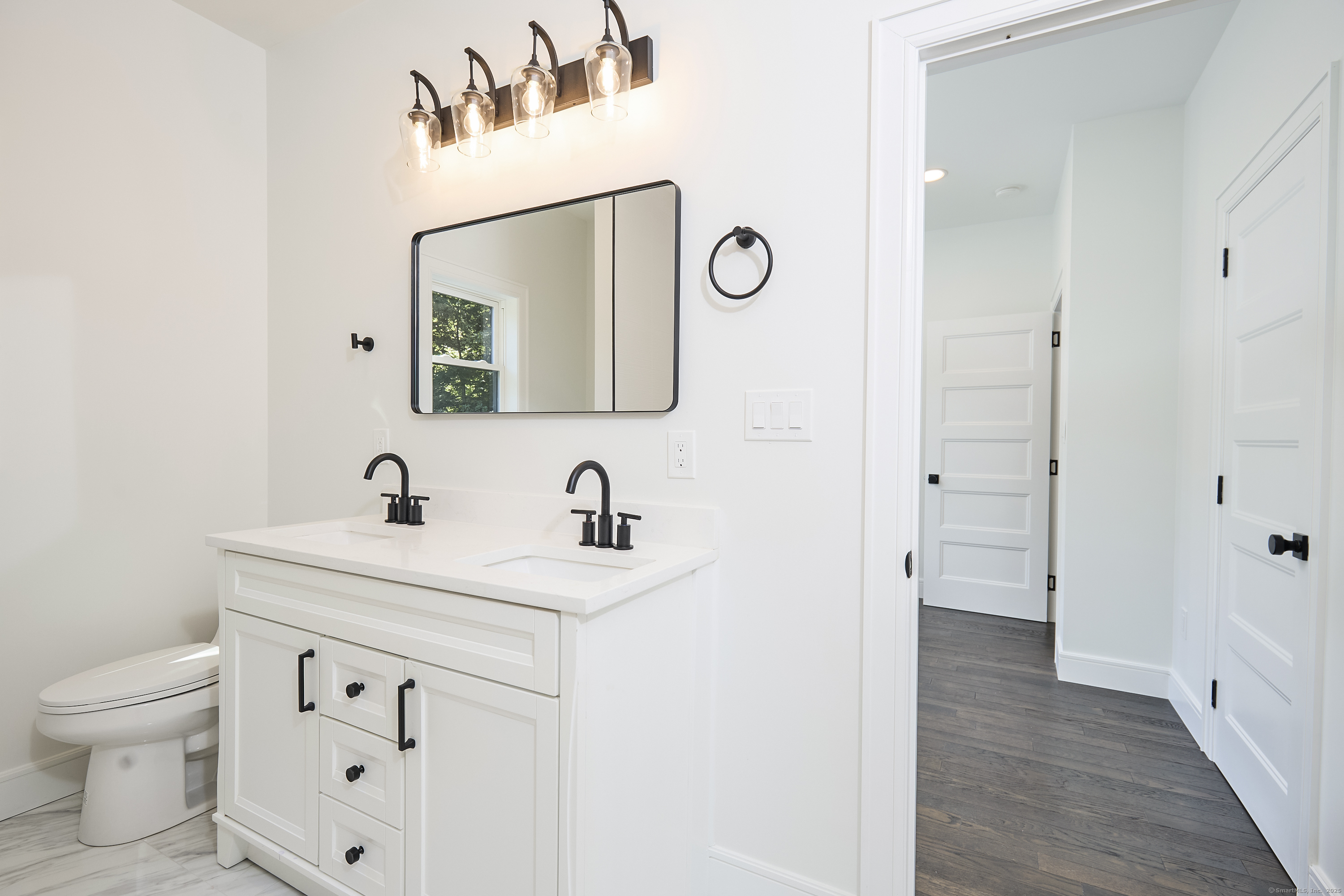 1207 Stillson Road Fairfield, CT 06824 - Photo 27 of 39 a bathroom with a sink and a mirror