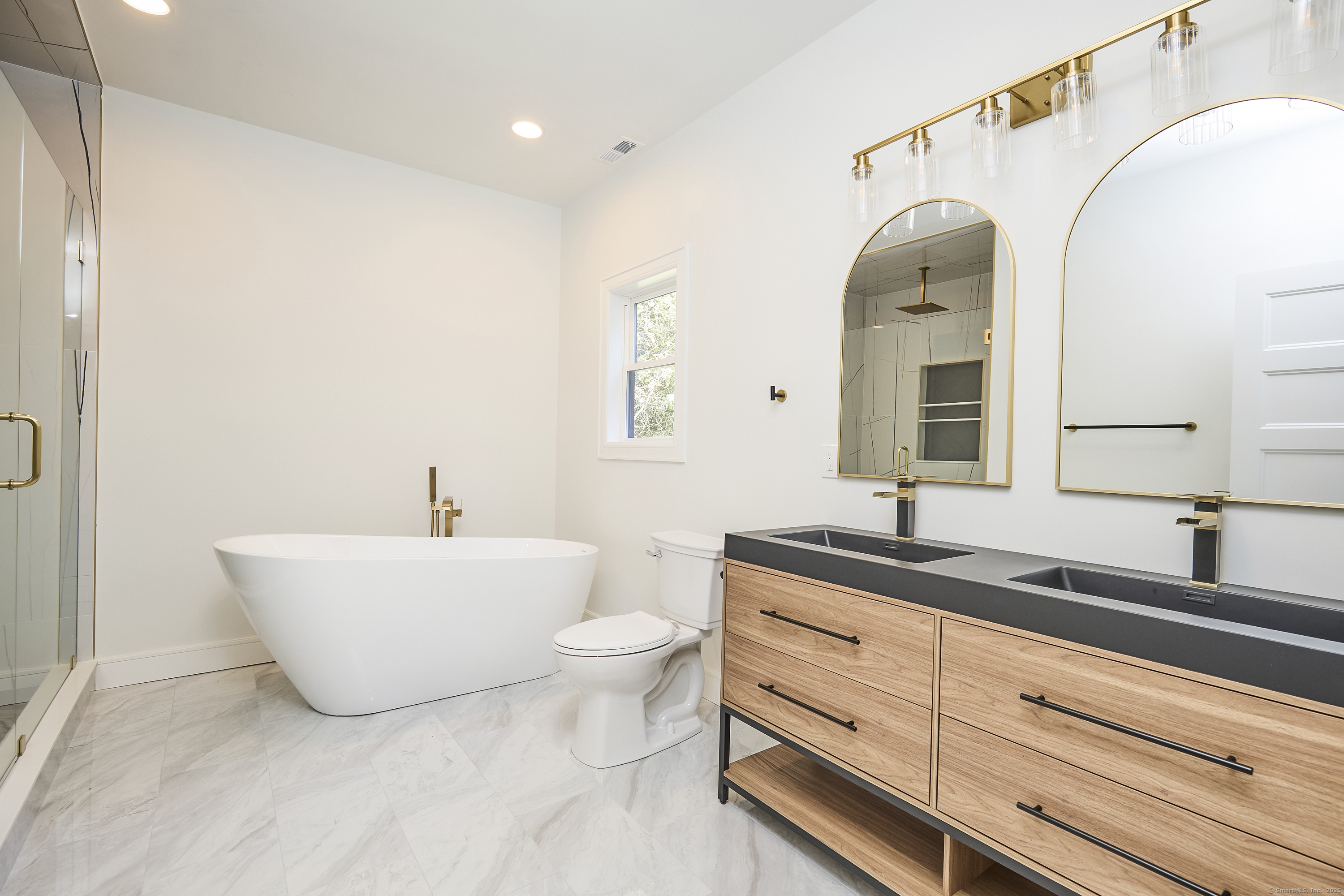 1207 Stillson Road Fairfield, CT 06824 - Photo 30 of 39 a bathroom with a granite countertop sink and a mirror