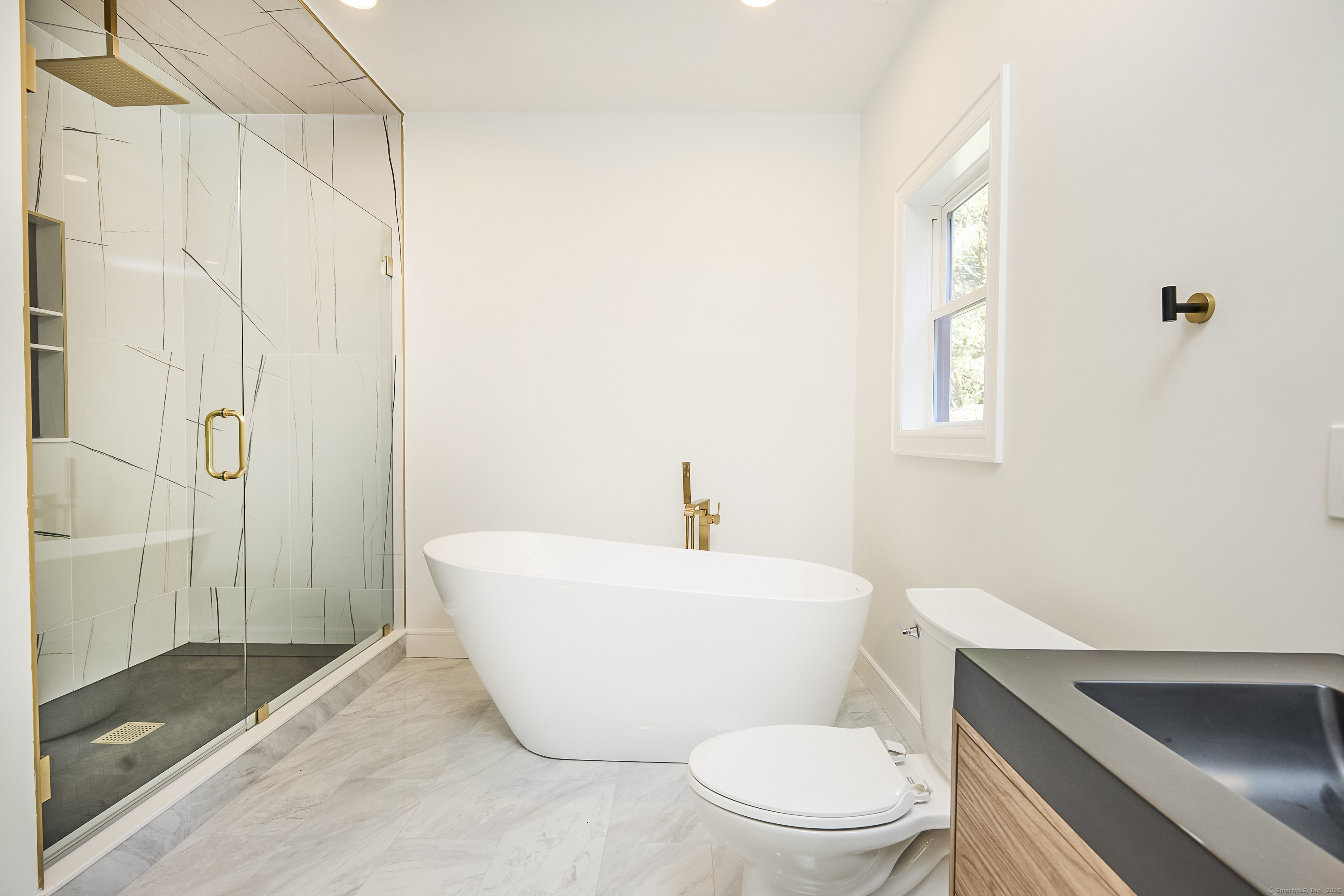 1207 Stillson Road Fairfield, CT 06824 - Photo 31 of 39 a white toilet sitting next to a bathroom sink