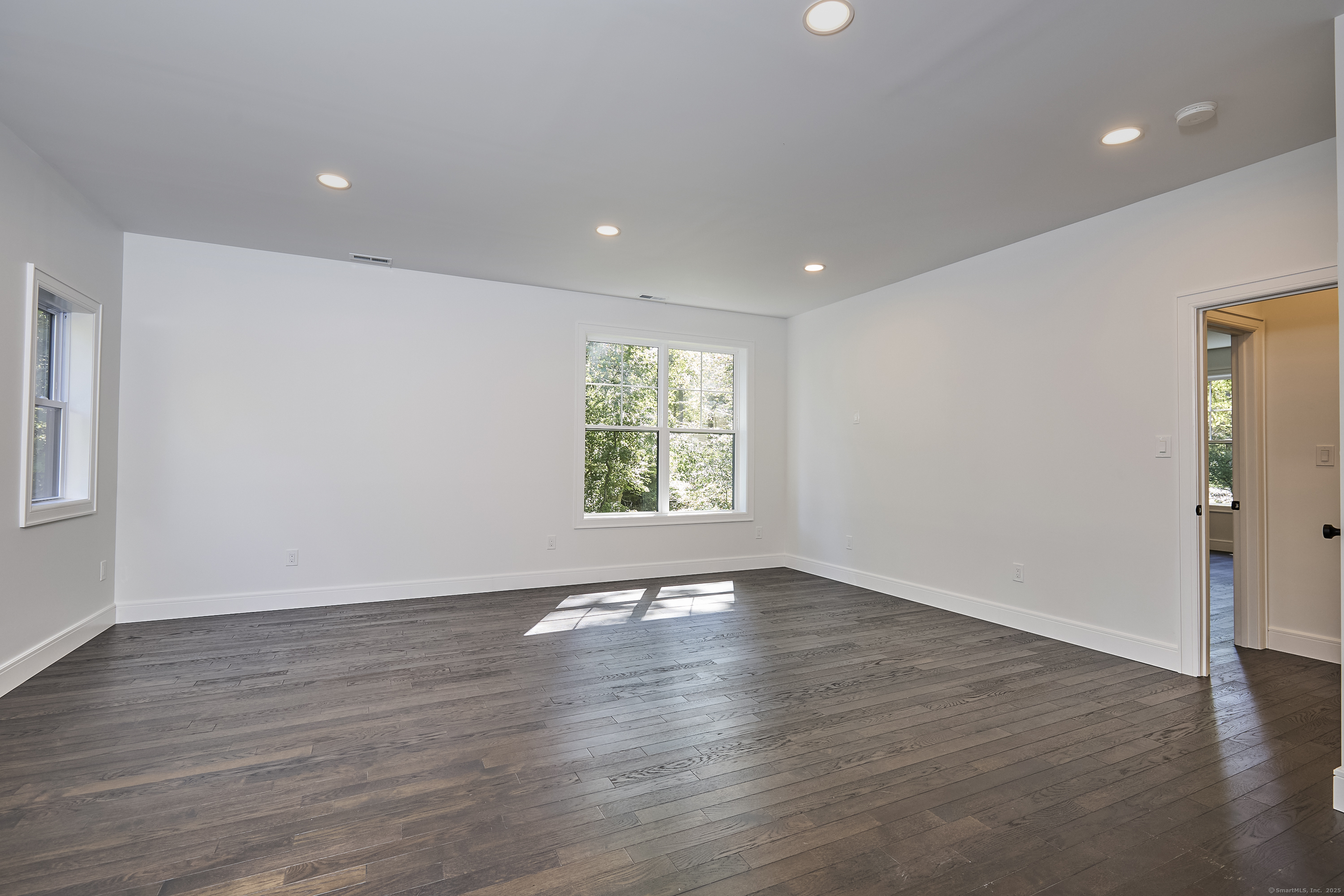 1207 Stillson Road Fairfield, CT 06824 - Photo 32 of 39 a view of an empty room with wooden floor and a window