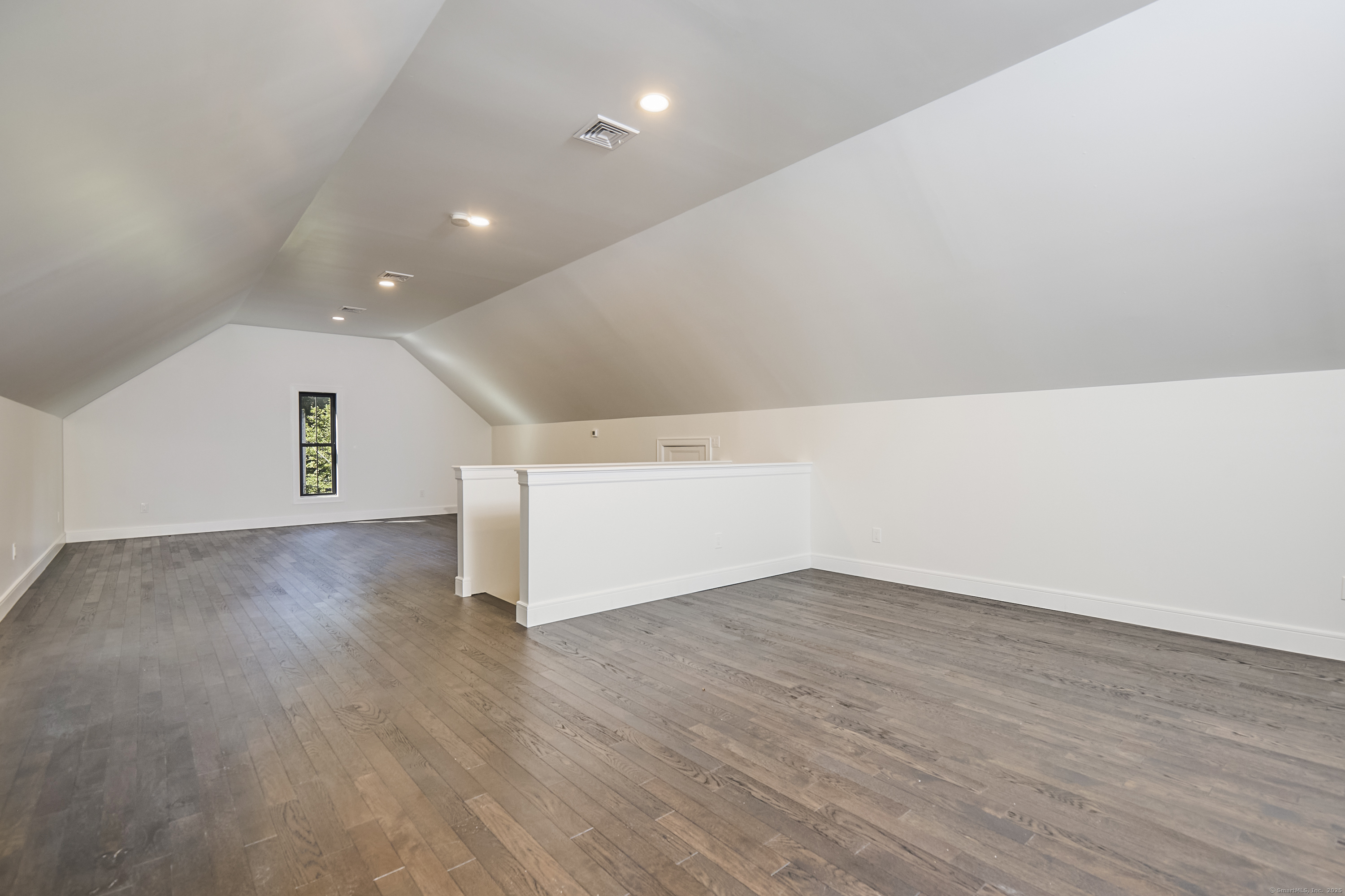 1207 Stillson Road Fairfield, CT 06824 - Photo 33 of 39 a view of empty room with wooden floor