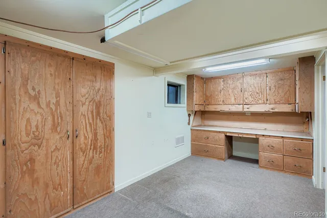 a kitchen with granite countertop a sink and cabinets
