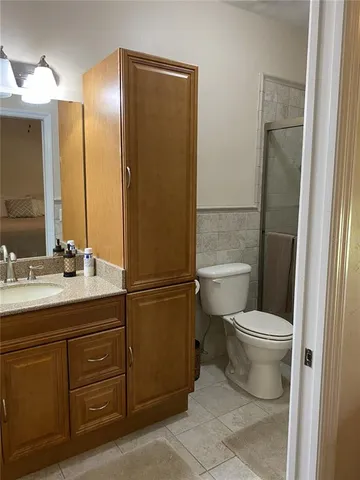 a white toilet sitting next to a shower