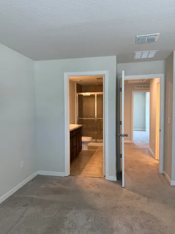 a bathroom with a granite countertop sink a toilet and shower