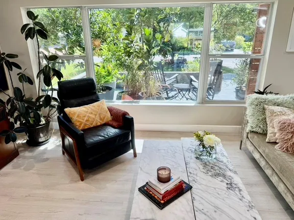 a bed sitting in a spacious bedroom next to a window
