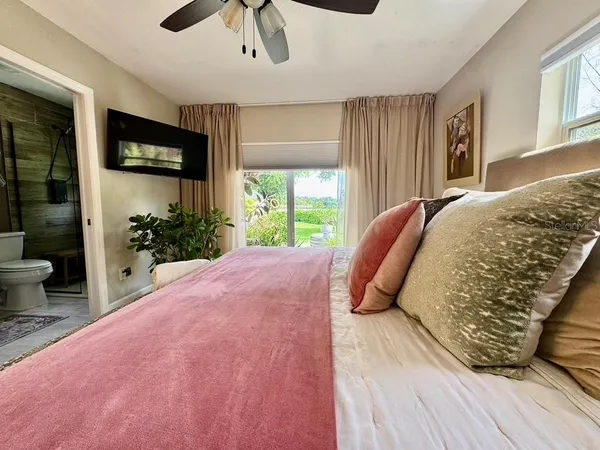 a bathroom with a double vanity sink toilet mirror and shower