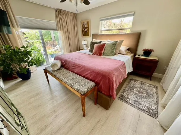 a bedroom with a bed and a potted plant