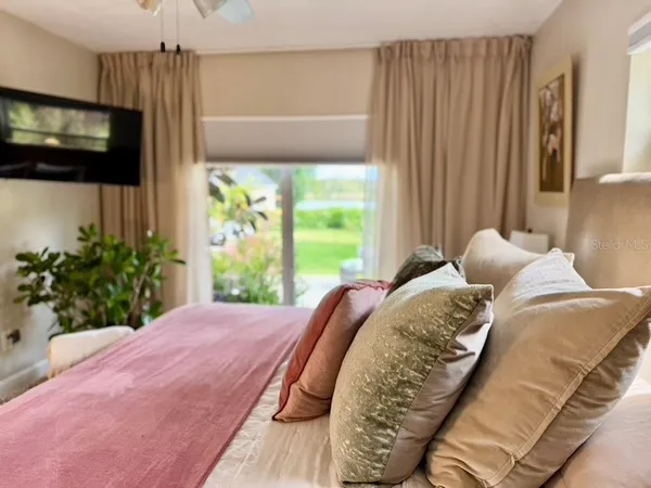 a bed sitting in a bedroom next to a window