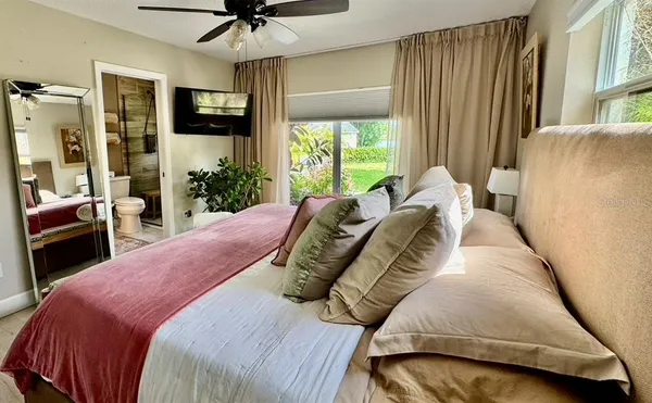 a bedroom with a bed and a painting on the wall