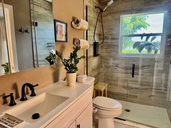 a living room with furniture and a lamp