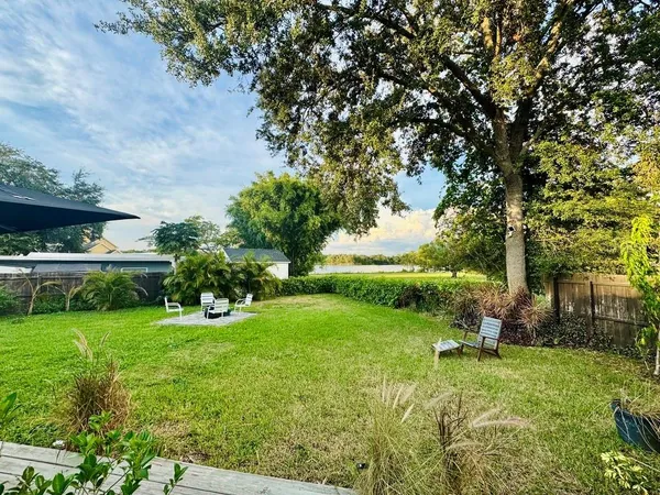 a living room with a table chair and a large window