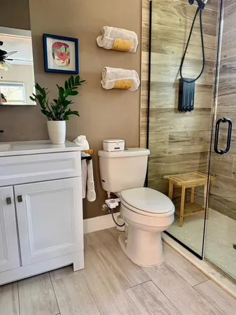 a bedroom with a bed and painting on the wall